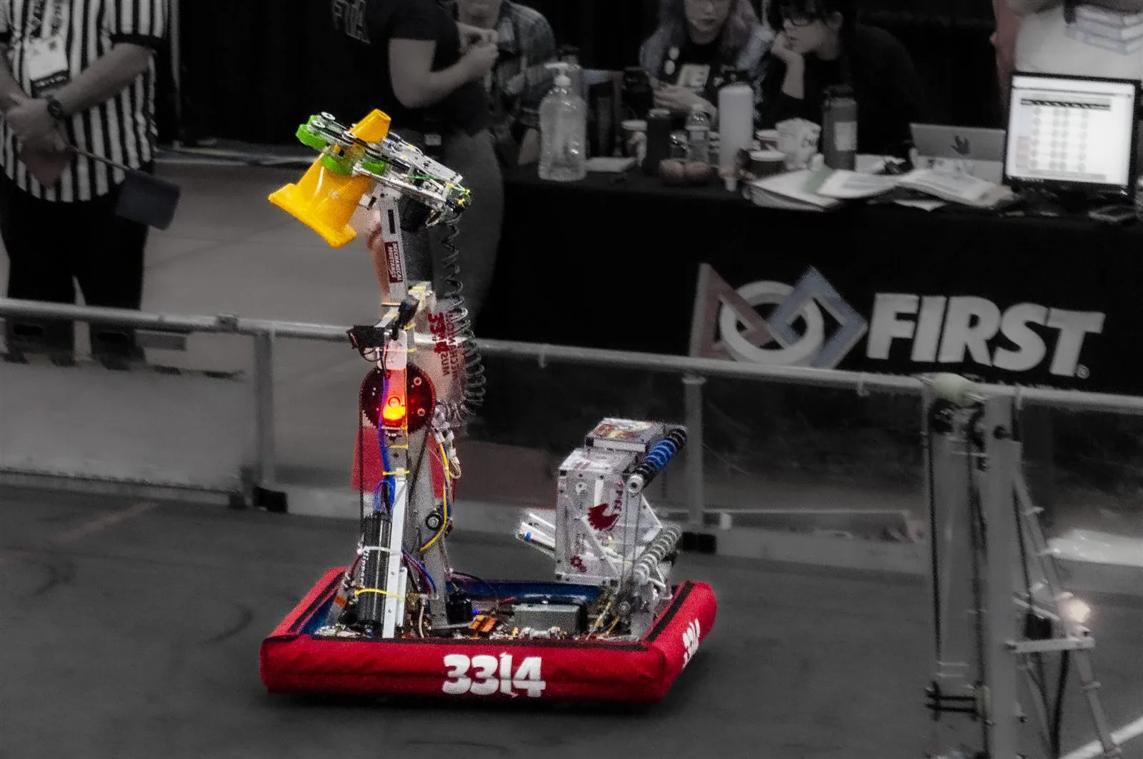 The 2023 robot carrying a cone during a CHARGED UP match