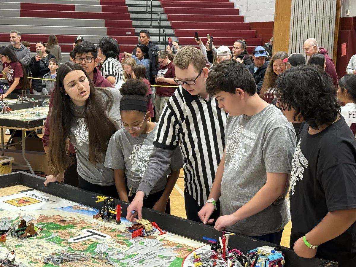 CCMS Mechanical Mustangs at the FLL competition table