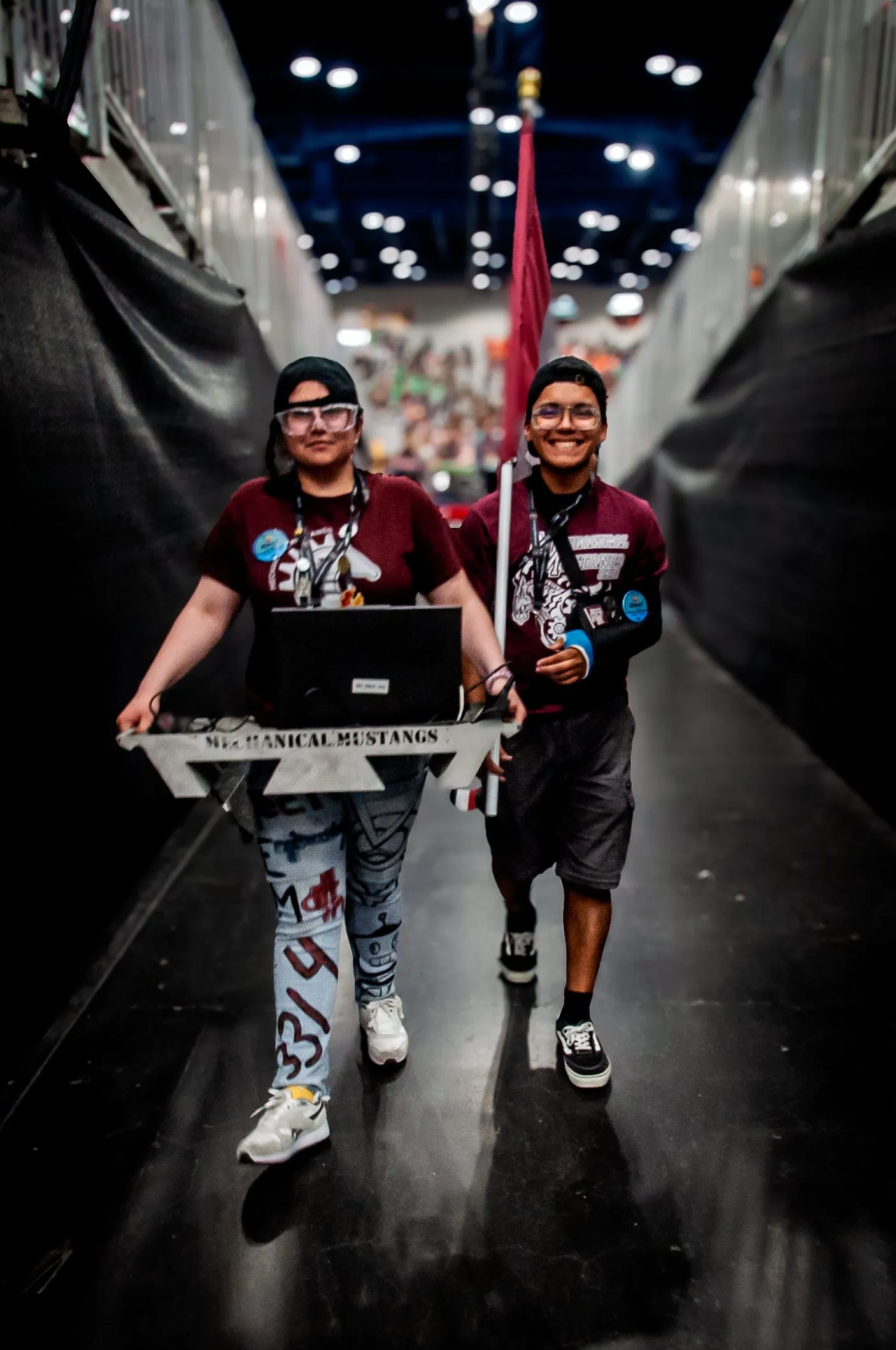 Two Mustangs carrying the team flag and driver station at the FIRST Championship
