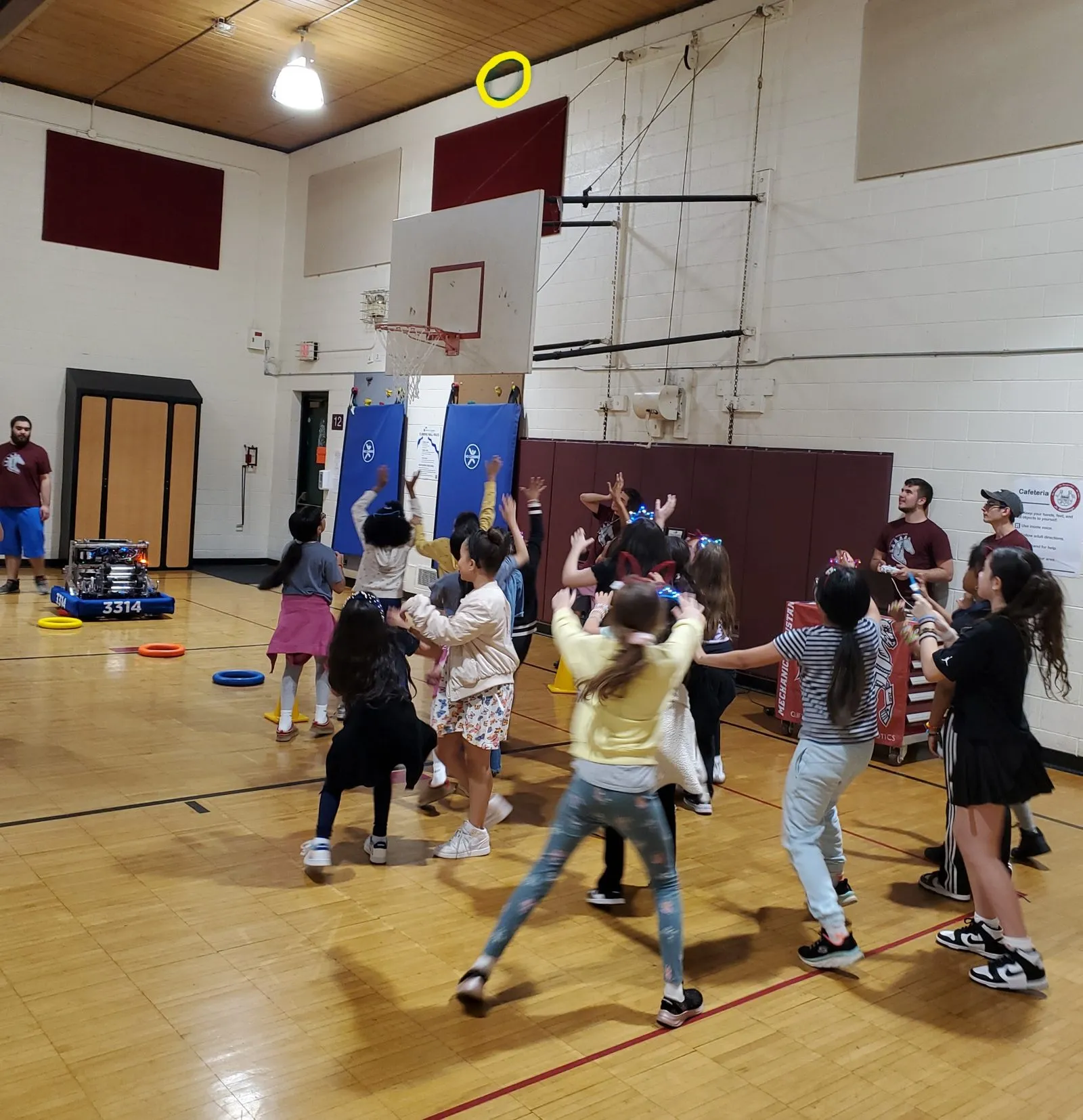 Kids playing ring toss with the robot at SPRING into STEM
