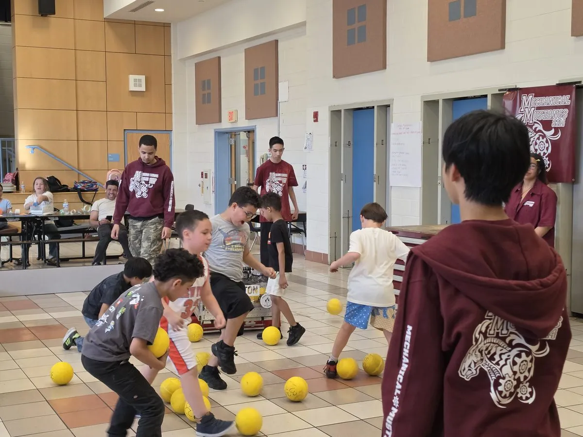 Kids playing with the robot at a STEM Family Night