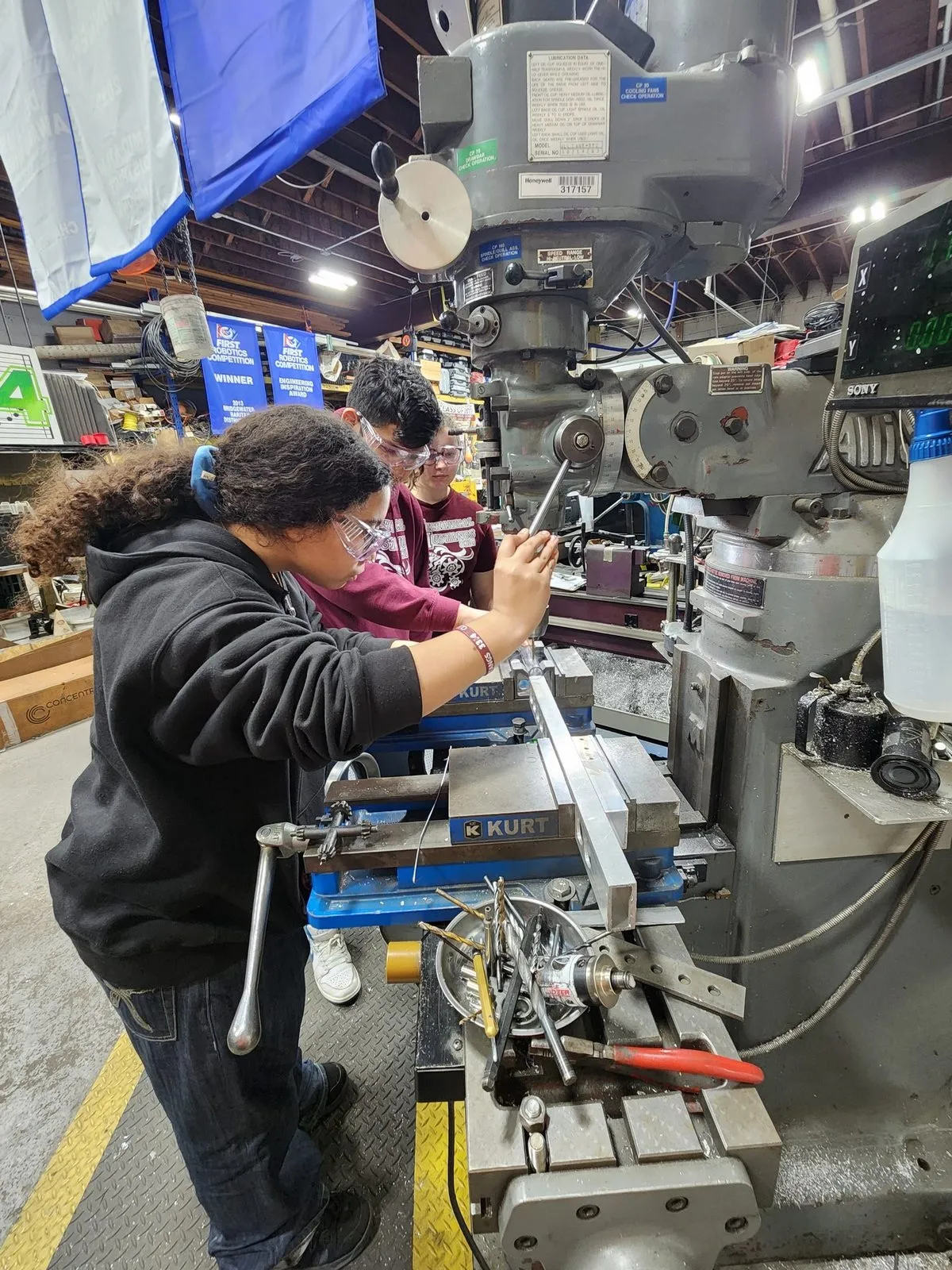 Students machining a part at the mill